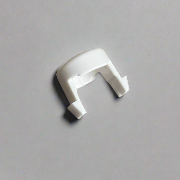 White plastic component on a gray background