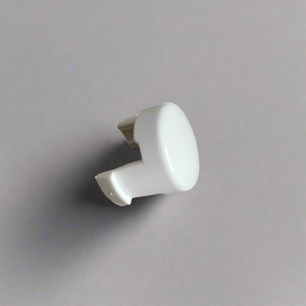 White plastic pushchair stroller button on a gray background